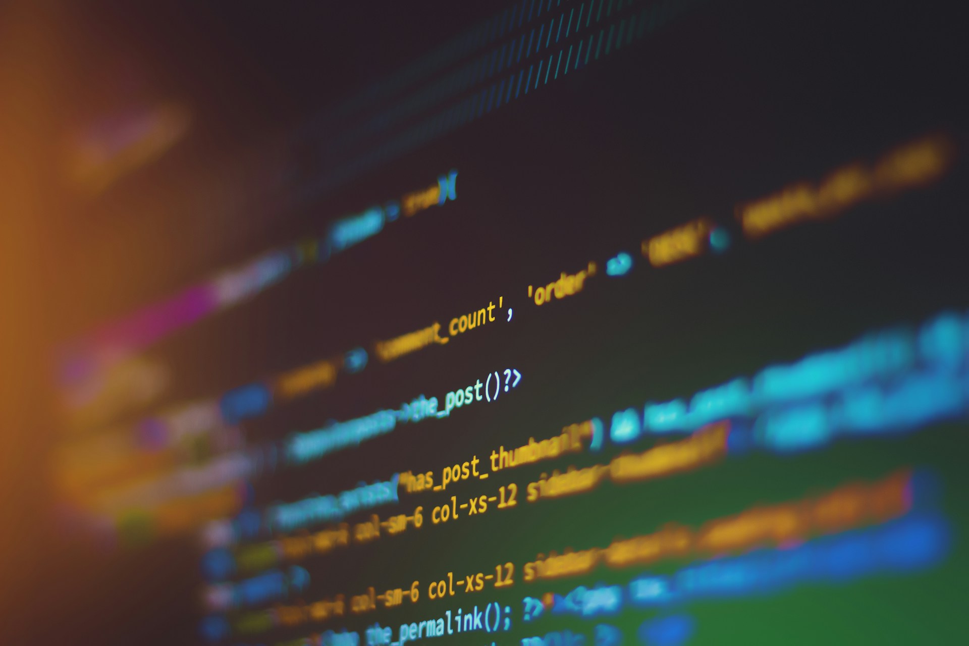 Close-up of code on a laptop screen, representing the technical literacy small business and board-level cyber security training aims to build.